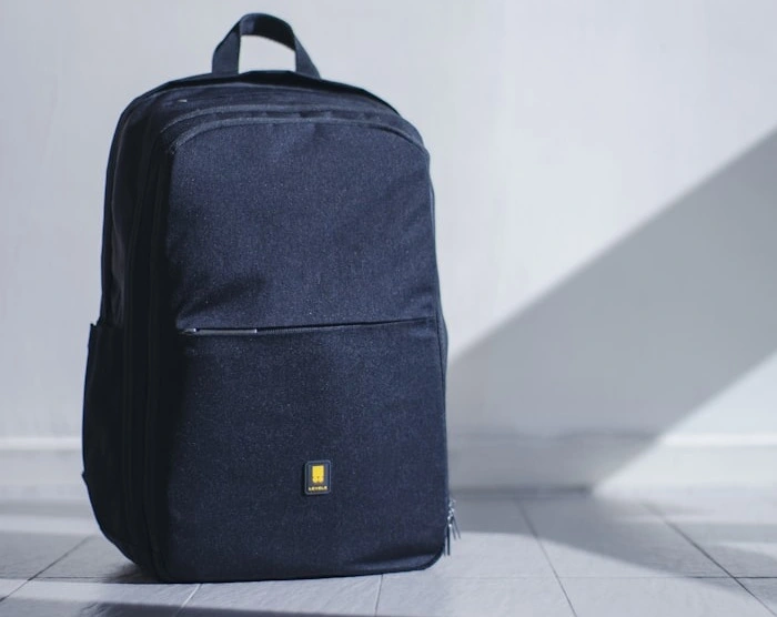 Black backpack on a floor.